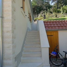 Stairs lead to the main entrance