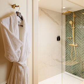 View inside of bathroom with bathrobe