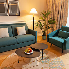 Hotel room with sofa bed and chair 