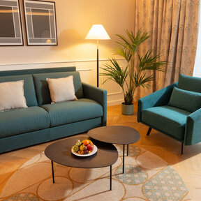 Hotel room with sofa bed and chair 