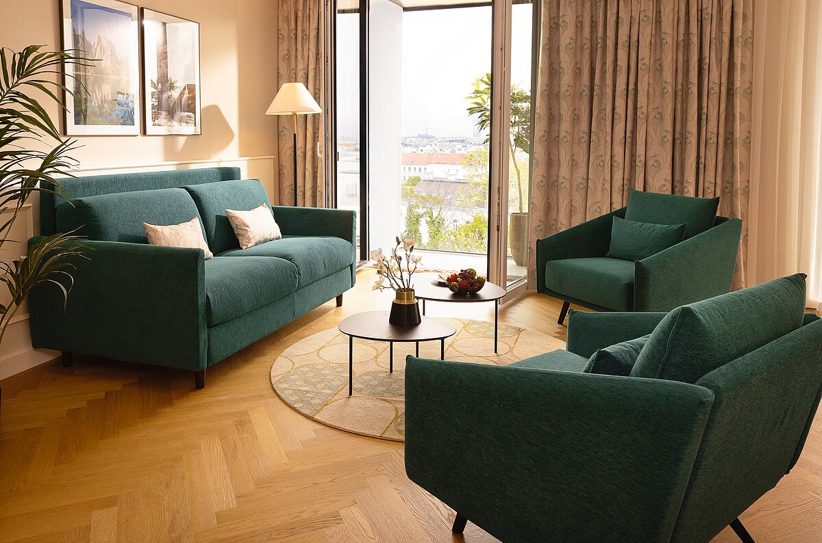 Sofabed with lounge chairs at Junior Suite