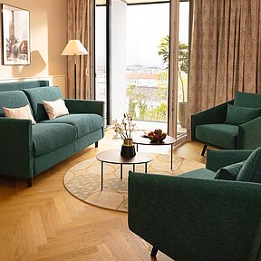 Sofabed with lounge chairs at Junior Suite