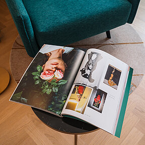 Detail view of cosy reading chair and table with magazine