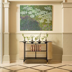 Detail of entrance hall showing picture and flower arrangement