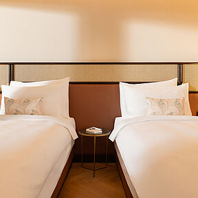 Hotel room with two single beds and high-quality bed linen