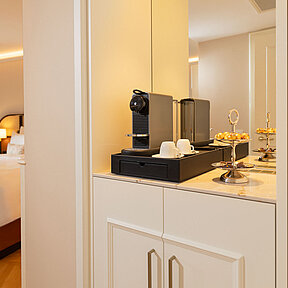 Elegant hotel room with Nespresso machine and minibar