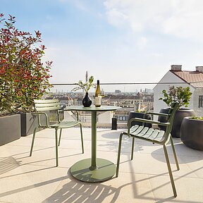 Roof top terrace with table and chairs and view over Vienna