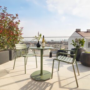 Roof top terrace with table and chairs and view over Vienna