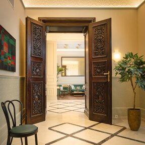 A historic wooden door leads into the hotel lounge